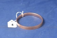 Lot 4 - A 9ct rose gold bangle with engraved...