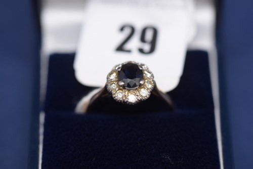 Lot 29 - A sapphire and diamond cluster ring, on 18ct....