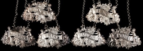 Lot 308 - Six mid 18th Century silver cast wine labels,...