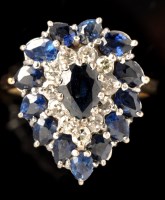 Lot 404 - A sapphire and diamond cluster ring, the...