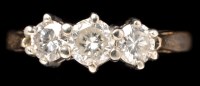 Lot 407 - A three stone diamond ring, the slightly...