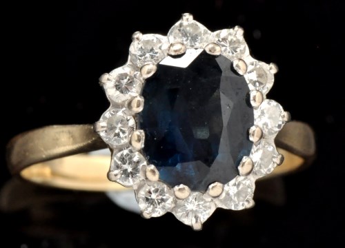 Lot 424 - A sapphire and diamond cluster ring, the...