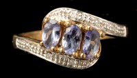 Lot 431 - A tanzanite and diamond ring, the three oval...