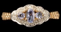 Lot 433 - A tanzanite and diamond cluster ring, the...