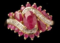 Lot 434 - A ruby and diamond dress ring, set with oval...
