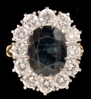 Lot 441 - A sapphire and diamond cluster ring, the oval...