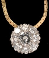 Lot 442 - A diamond cluster pendant, the central...