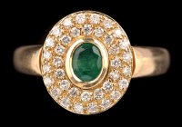 Lot 445 - An emerald and diamond cluster ring, the...
