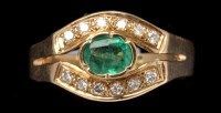 Lot 449 - An emerald and diamond ring, the oval facet...
