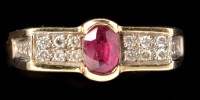 Lot 450 - A ruby and diamond ring, the oval facet cut...