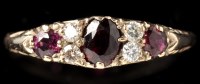 Lot 460 - A ruby and diamond ring, the oval facet cut...