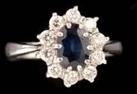 Lot 462 - A sapphire and diamond cluster ring, the oval...