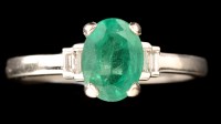 Lot 463 - An emerald and diamond ring, the oval facet...