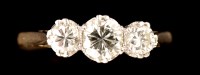 Lot 469 - A three stone diamond ring, the central...