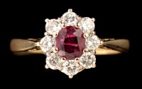 Lot 472 - A ruby and diamond cluster ring, the central...