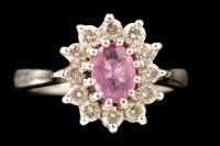 Lot 473 - A pink sapphire and diamond cluster ring, the...