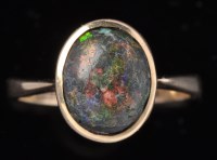 Lot 475 - A black opal ring, the oval cabochon opal in...