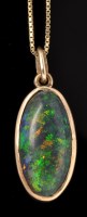 Lot 477 - A black opal pendant, the oval opal cabochon...