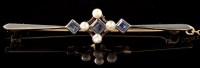 Lot 486 - A sapphire and pearl bar brooch, the...