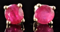 Lot 488 - A pair of ruby stud earrings, the slightly...