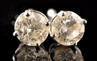 Lot 493 - A pair of diamond stud earrings, each...
