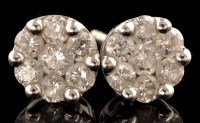 Lot 495 - A pair of diamond cluster stud earrings, each...