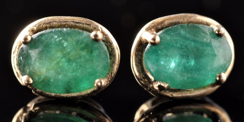 Lot 497 - A pair of emerald stud earrings, the oval...