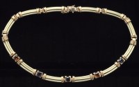 Lot 513 - A gem set yellow metal necklace, each link...