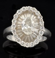 Lot 515 - A diamond cluster dress ring, the central oval...