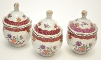 Lot 578 - Set of three Famille Rose jars with domed...