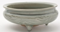 Lot 597 - Celadon tripod censer, of squat form, with...