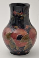 Lot 690 - Moorcroft 'Pomegranate' baluster vase, with...