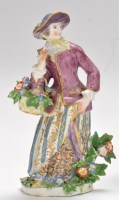 Lot 710 - Bow figure of a flower girl, standing holding...