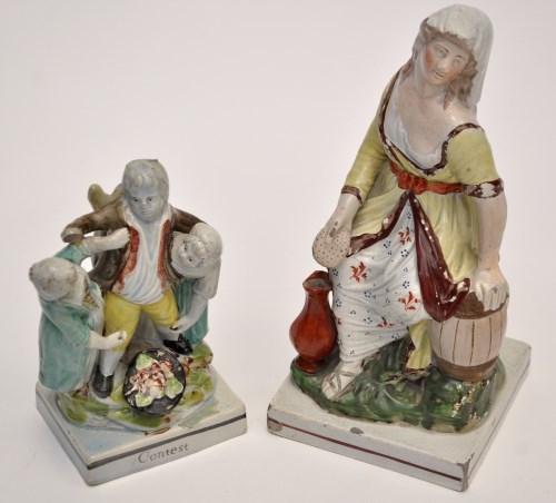 Lot 715 - Pearlware figure of washer woman, seated...