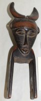 Lot 776 - A West African guro carved wooden heddle...