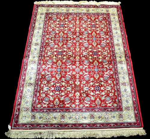 Lot 812 - A woven Kashmir rug, with full floral design...