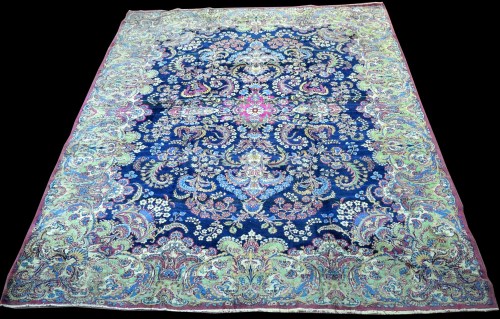 Lot 818 - A Kirman carpet, the bold floral scrolling...