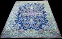 Lot 818 - A Kirman carpet, the bold floral scrolling...