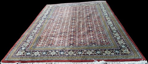 Lot 831 - A Tabriz carpet, with flowerhead decoration on...