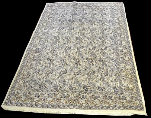 Lot 863 - A Kirman carpet, decorated with boteh motif on...