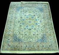 Lot 870 - A Kashan rug, the floral design on ivory...