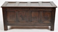 Lot 948 - An oak coffer, the panel top opening to reveal...