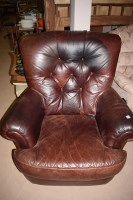 Lot 565 - A pair of brown leather button back armchairs,...