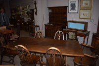Lot 632 - An oak dining room suite, by G.T. Rackstraw,...