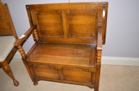 Lot 680 - A 20th Century oak monk's bench with carved...