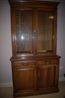 Lot 691 - An early 20th Century oak bookcase, the glazed...
