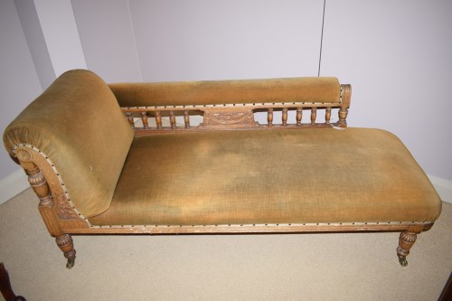 Lot 693 - A Victorian carved oak chaise longue, the legs...