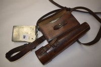 Lot 291 - A brown leather riding pouch, with flask...
