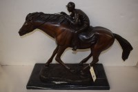 Lot 371 - A patinated bronze sculpture of a racing horse...
