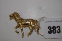 Lot 383 - A 9ct. yellow gold and diamond stallion brooch,...
